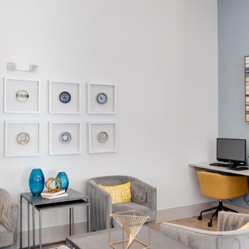 a room with a desk and chairs