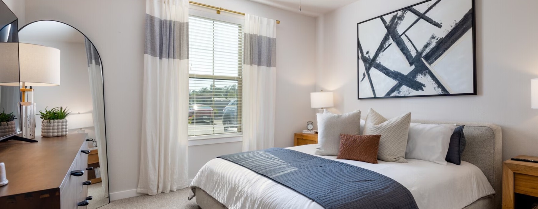 a bedroom with a bed and a fan