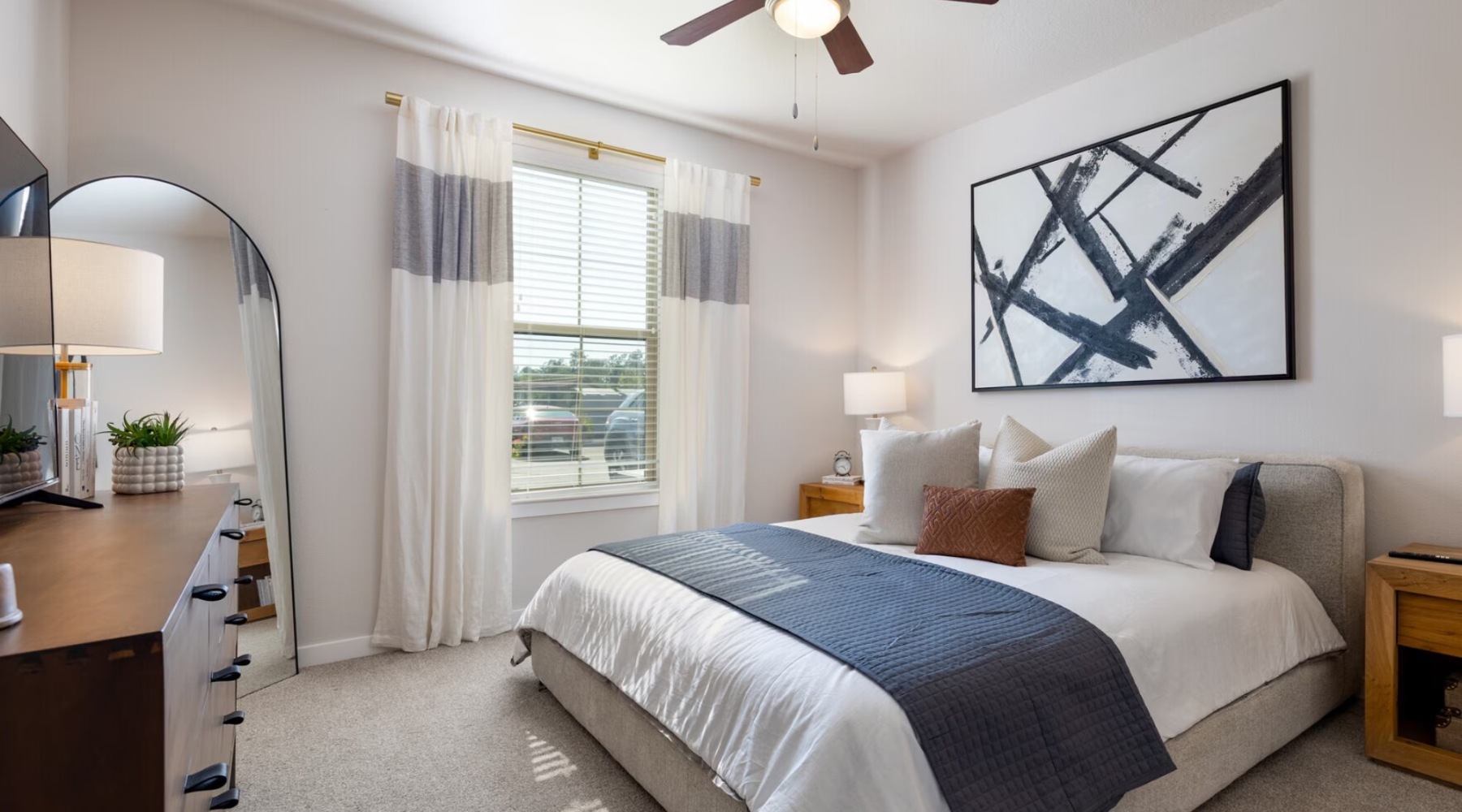 a bedroom with a bed and a fan