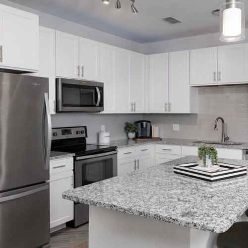 a kitchen with white cabinets