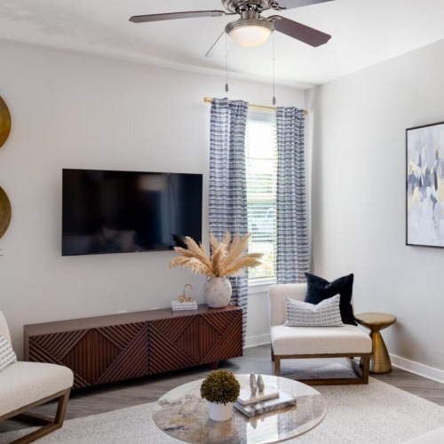 a living room with a ceiling fan and a couch